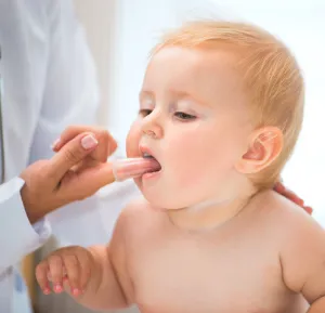 doctor checking a toddler's teeth