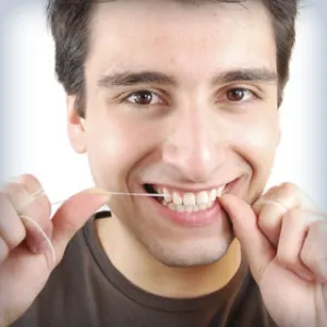person flossing their teeth